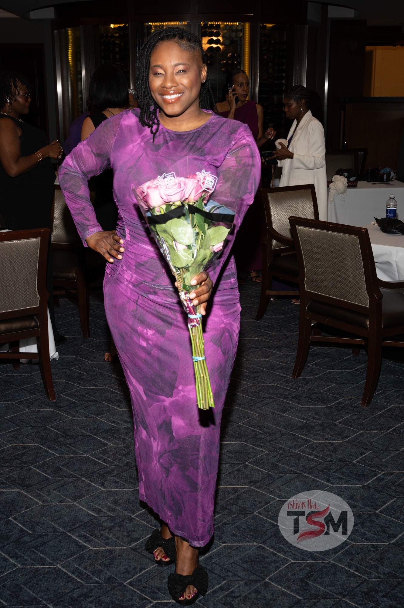 Dr. Crystal Jordan, L.H.D., wearing a purple dress at an Auesomely Her event