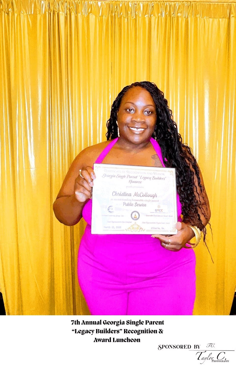 Christina McCollough holding a recognition certificate